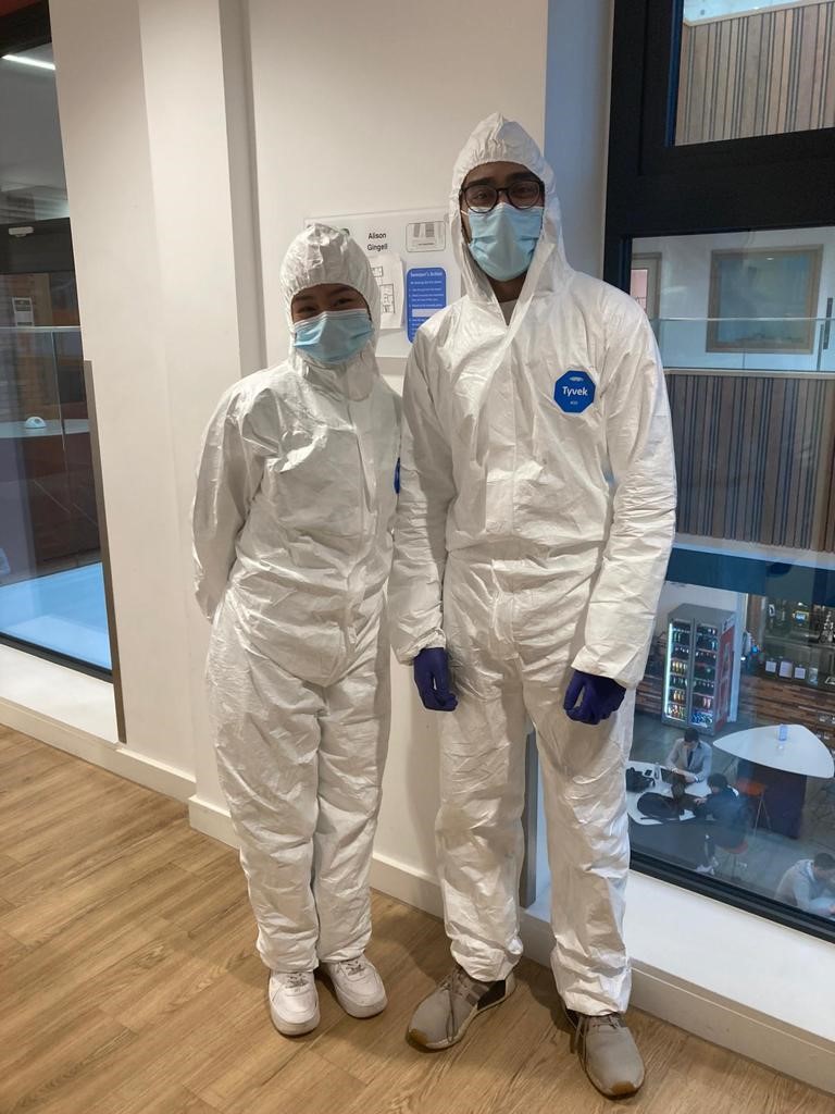 Student Ambassadors dressed in forensic investigator suits 